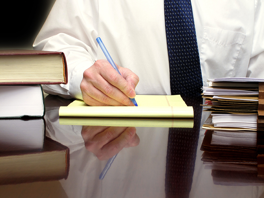 Employment Policies and Procedures table with textbooks and notepad